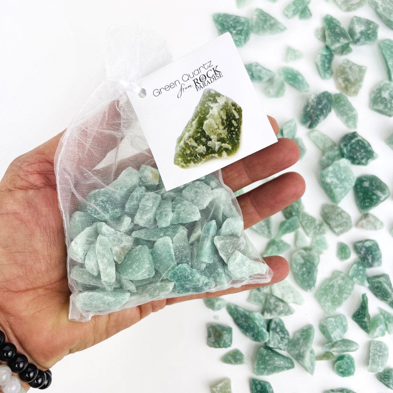 Green Quartz Stones - Tied & Tagged in an Organza Bag in a hand for size