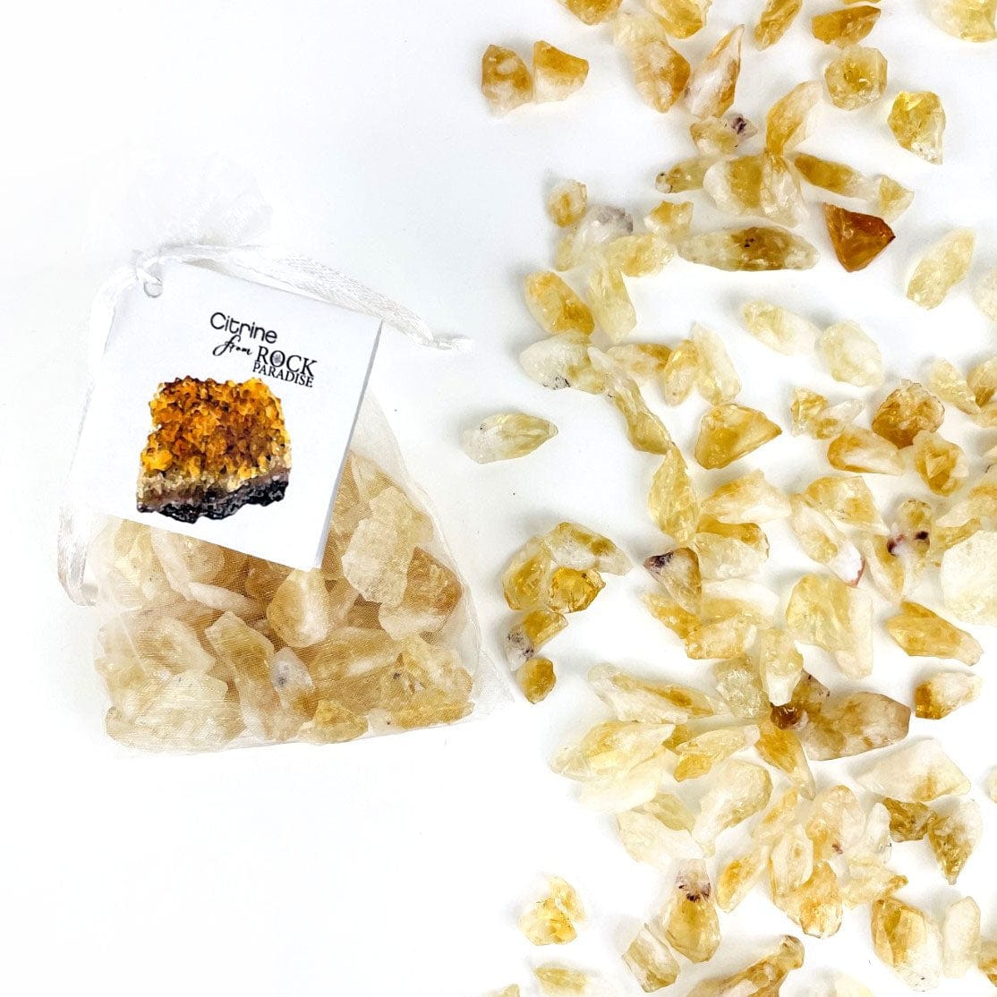 Citrine Stones - Golden Amethyst - Tied & Tagged in an Organza Bag next to some spread on a table
