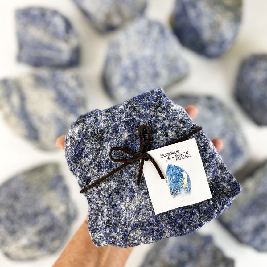 Sodalite Chunk - SUPER SIZE held in a hand for size., with other sodalite stones in the background