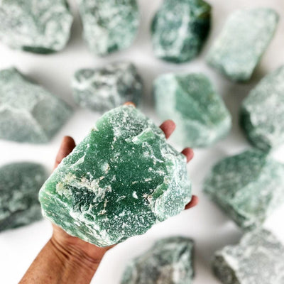 Green Quartz Quartz Chunk - SUPER SIZE in a hand for size reference with other stones in the background