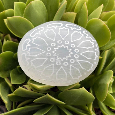 close up of selenite mandala engraved palm stone for engraving details