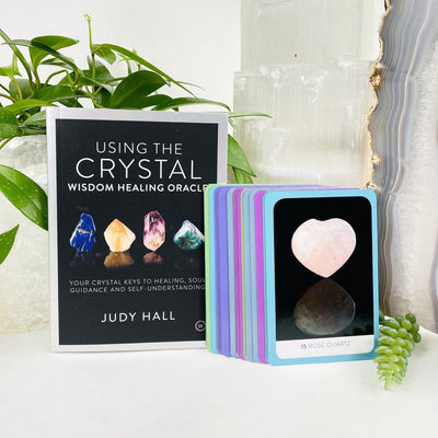 The Crystal Wisdom Healing Oracle by Judy Hall  with some cards outside the box to view 