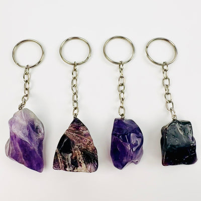 Amethyst Polished Freeform Silver Toned Key Chain - Tumbled Purple Stone - Top view of four key chains