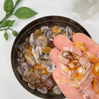 Golden Healer Tumbled Chips in hand for size reference 