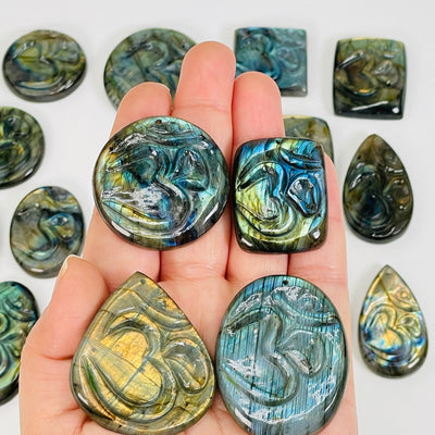 labradorite drilled pendants in hand for size reference 