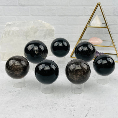 multiple spheres displayed to show the differences in the sizes and color shades 