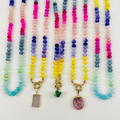 multiple rainbow candy necklaces displayed to show the differences in the color shades  