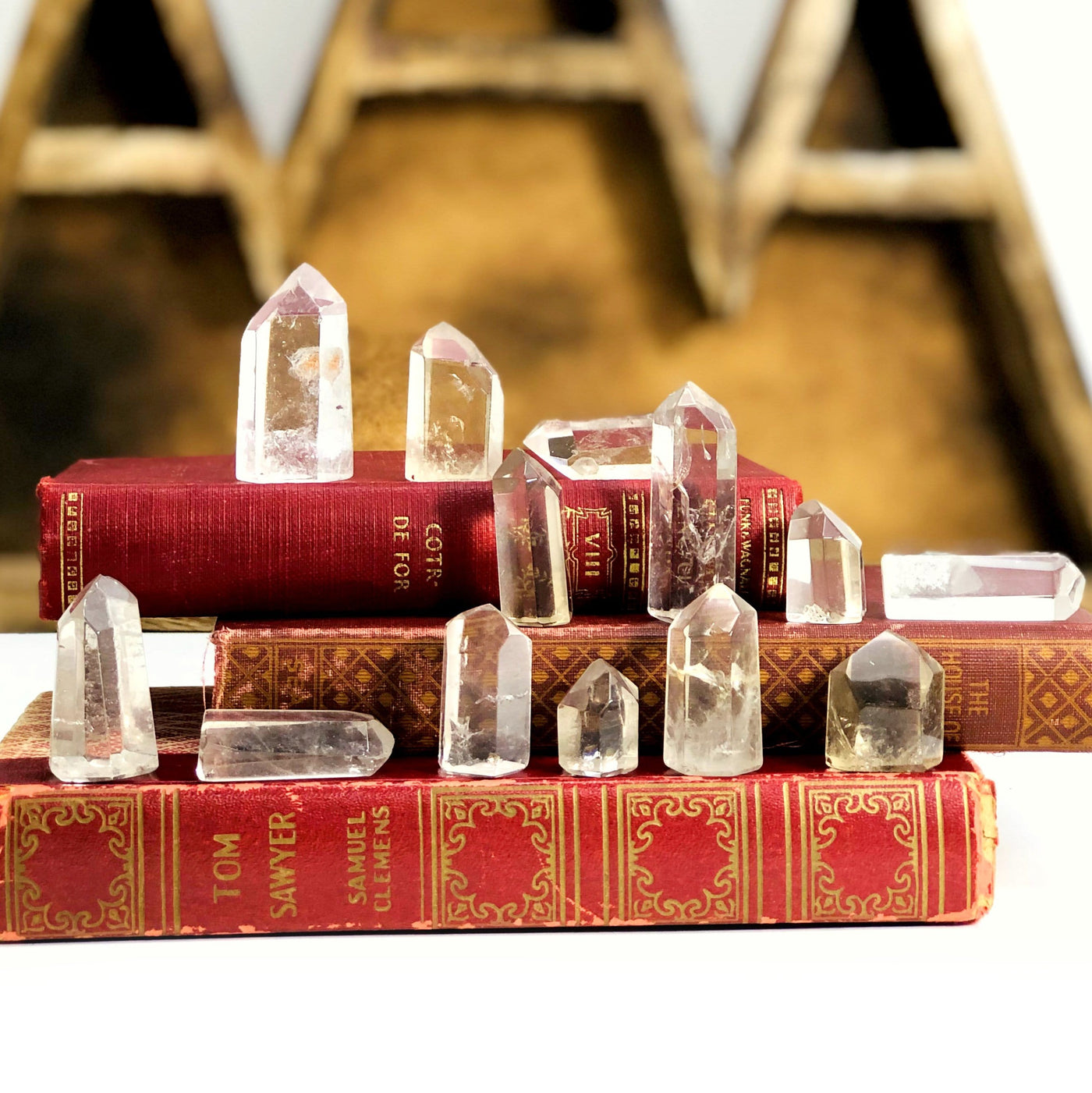 Crystal Quartz Polished Points layed out on books, showing range of variation of stock available