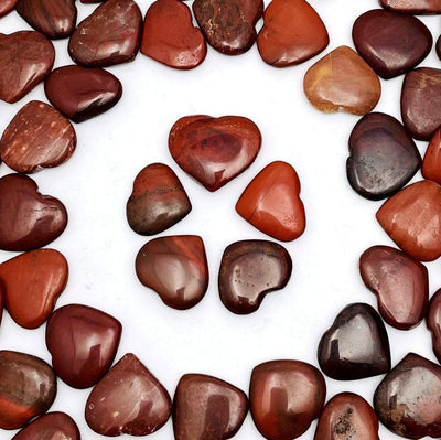 5 Red Jasper Heart Shaped Stones in a circle surrounded by more on white background