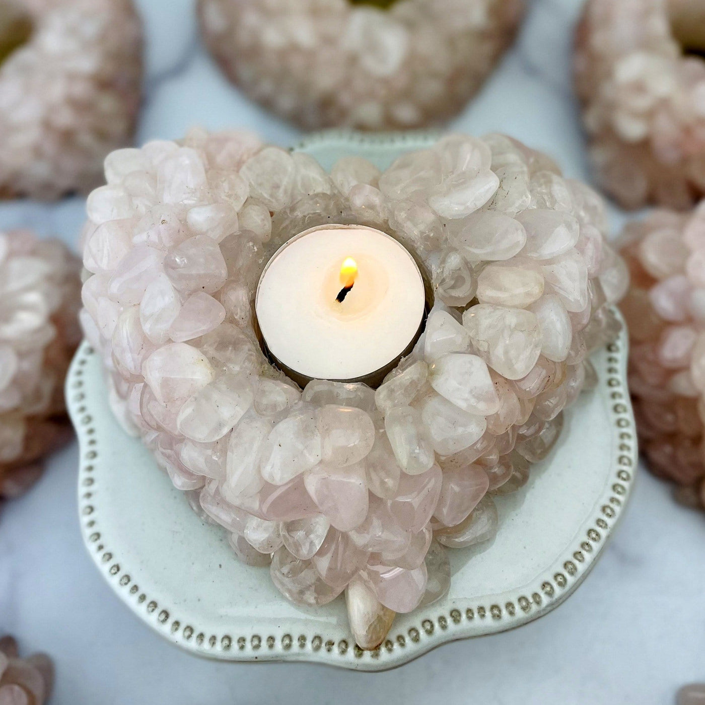 Up close shot of Rose Quartz Tumbled stone Heart Candle Holder with candle inside