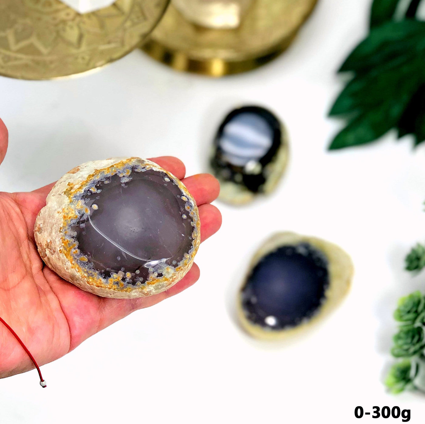 0-300 g Agate Enhydro Semi-Polished Geode shown in a hand within an alter.