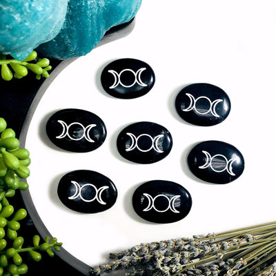 Multiple Black Obsidian Palm Stones Pocket Stones with Moon Phase in white background