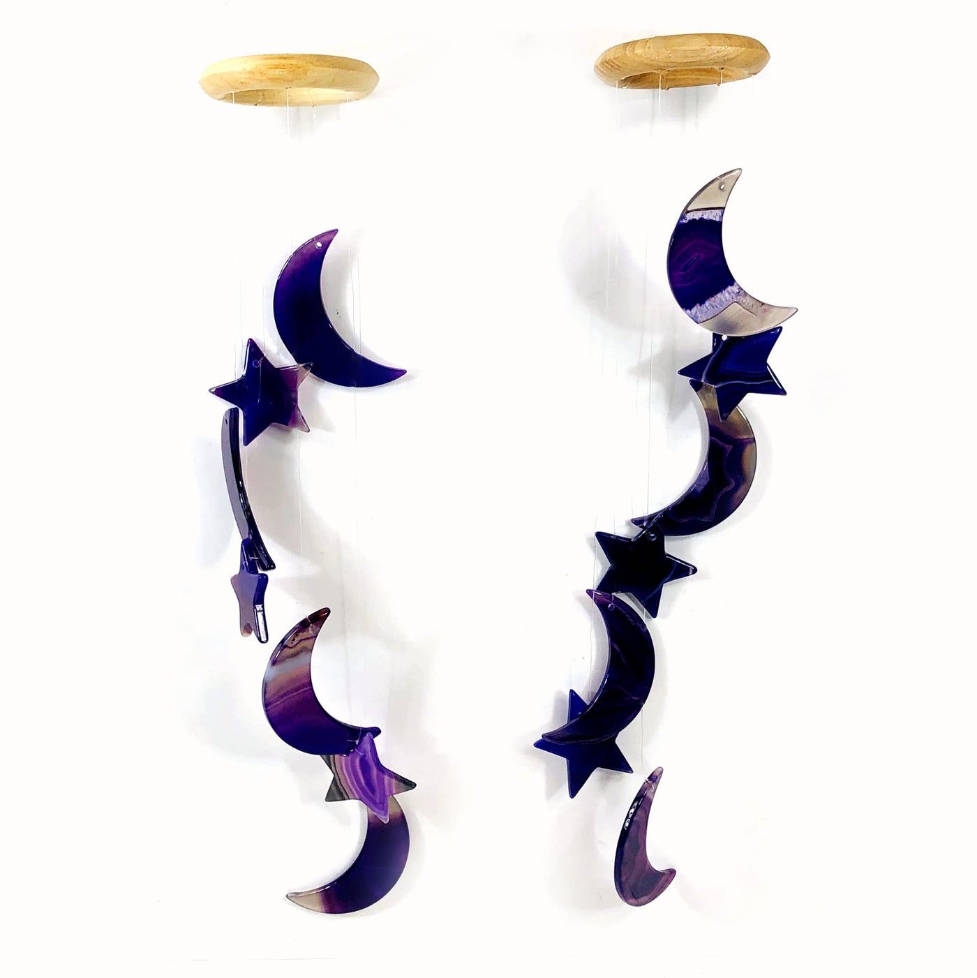 Two purple Agate Moon and Star Wind Chimes  hung with a white background.