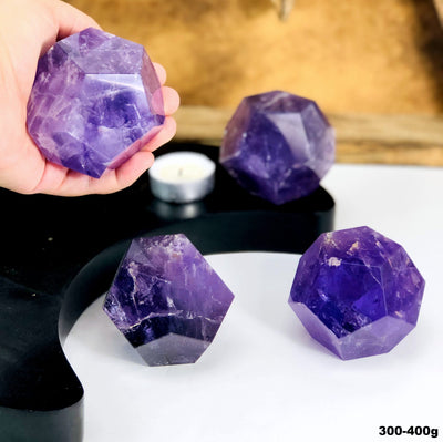 Amethyst Dodecahedron Stones --close shot view of dodecahedron size 300-400 grams in hand for size comparison.