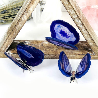 Purple Agate Druzy Butterfly Stands in an alter with crystals and flowers.