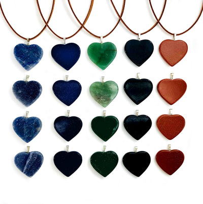 multiple heart slice pendants with silver toned bail with string on them to show as a neckless and some without string