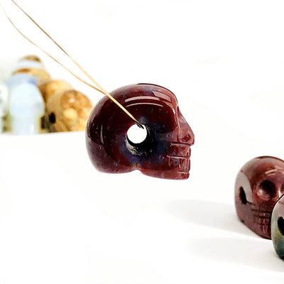 side view of one skull bead with wire through drill hole