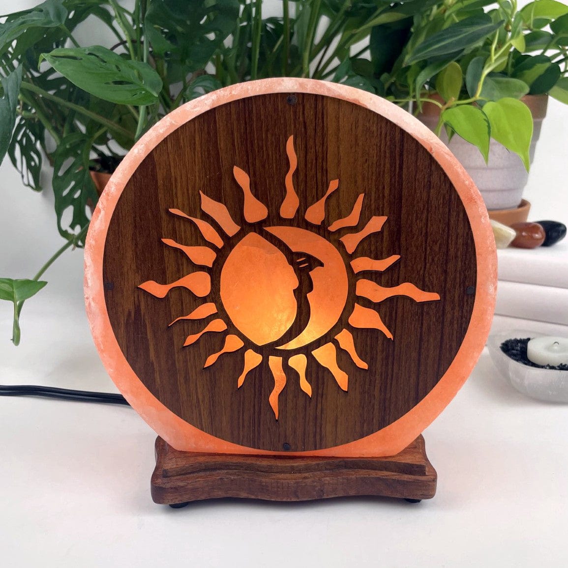 Himalayan salt lamp with sun moon design upside down sold as is shown here with light on front view