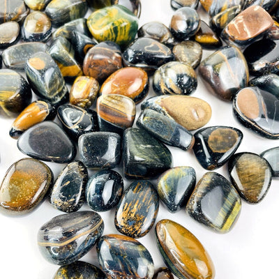 Blue Tigers Eye Polished Stones spread out on a table