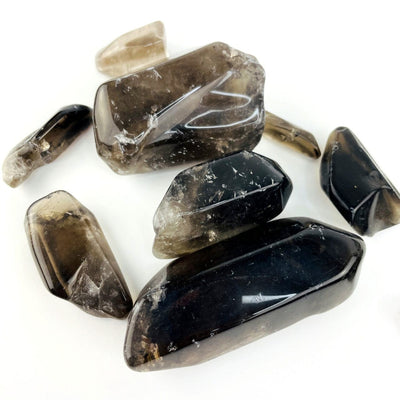 Close up of polished Smoky Quartz Tumbled Stones and Points