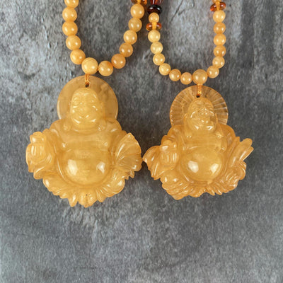 Amber Beaded Necklaces with Carved Buddha Pendants with the pendants up close