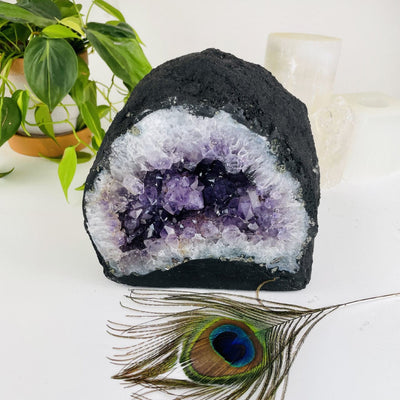 Amethyst Cathedral Geode Crystal with decorations in the background