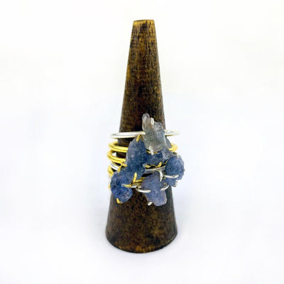 Tanzanite Gemstone Rings in Gold and Silver stacked on display