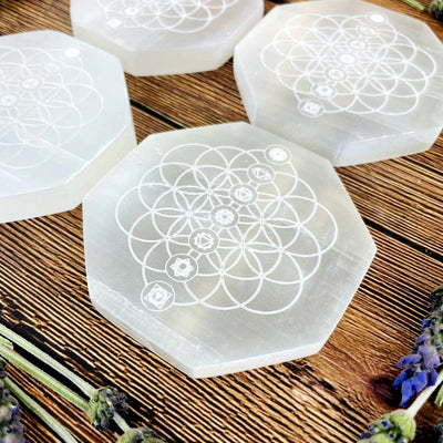 angled view of selenite hexagons engraved with flower of life chakra for details