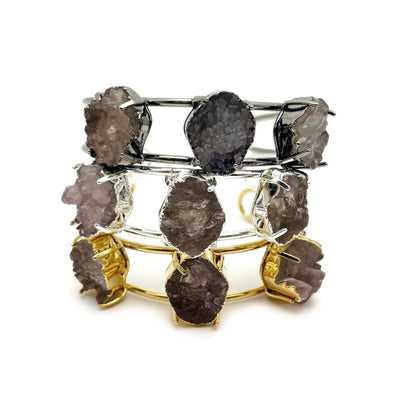 Druzy cuff bracelets in gold plating, silver plating and gunmetal plating on a white background.