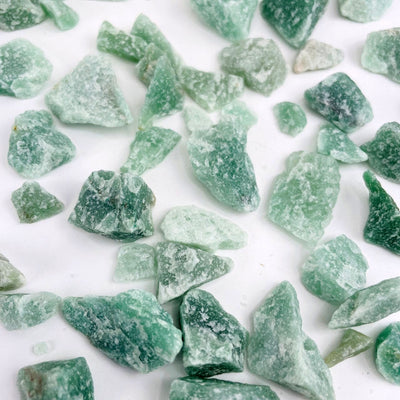 Green Quartz Stones spread out on table