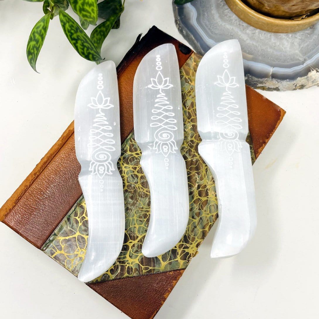 selenite knives with unalome engraving on display for possible variations and engraving details