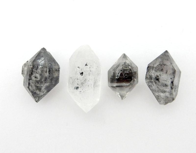 Assorted tibetan crystal quartz double terminated on a white background.