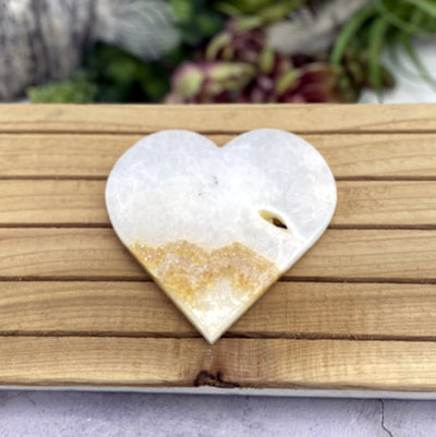 Aragonite Heart with decorations in the background