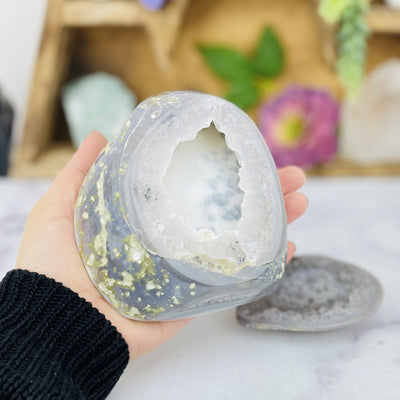 Agate Geode Box in a hand, decorations in the background.