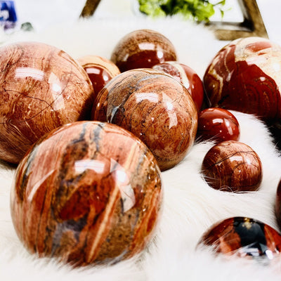 Up close shot of Red Jasper Polished Spheres on white fur background