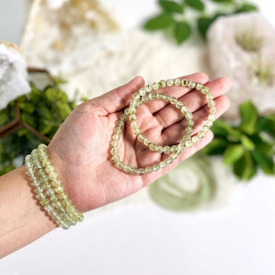 prehnite bracelet on a wrist and in a hand