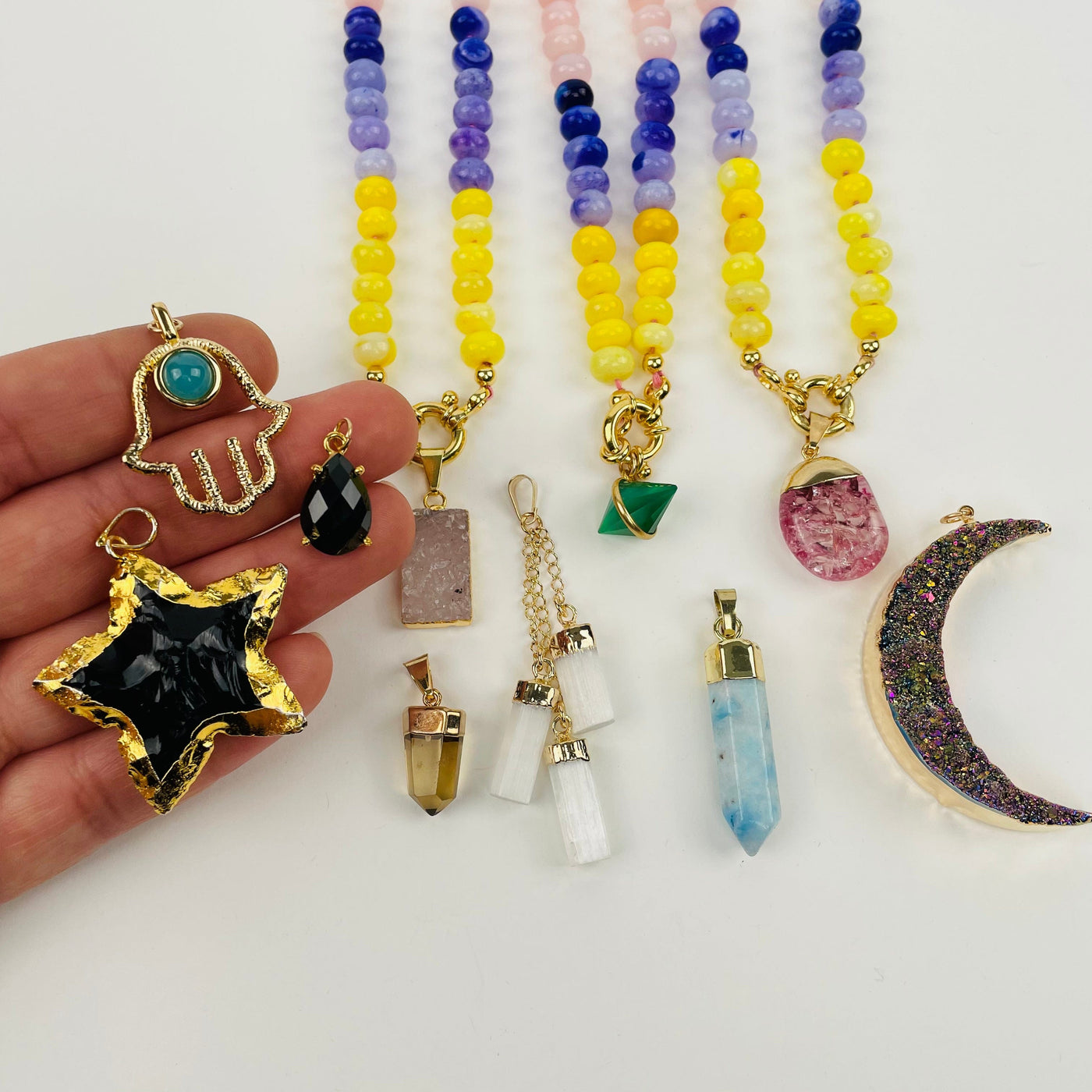 pendants displayed in hand for size reference