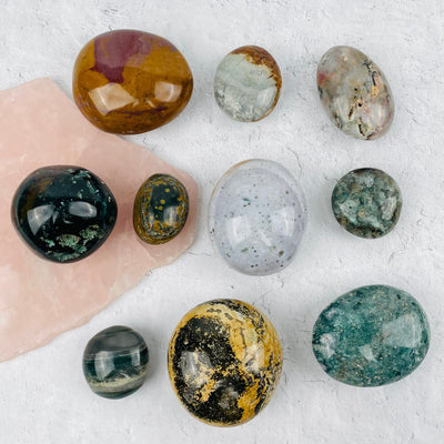 multiple palm stones displayed to show the difference in the sizes and color shades 