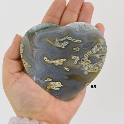 Close up of agate heart slice #5 in a hand.