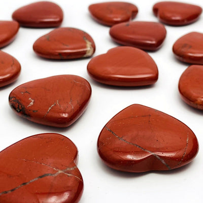 Side view of Red Jasper Heart Shaped Stones on white background