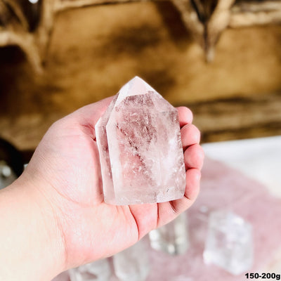 Crystal Quartz Polished Cut Base Point in a hand in the 150-200g size