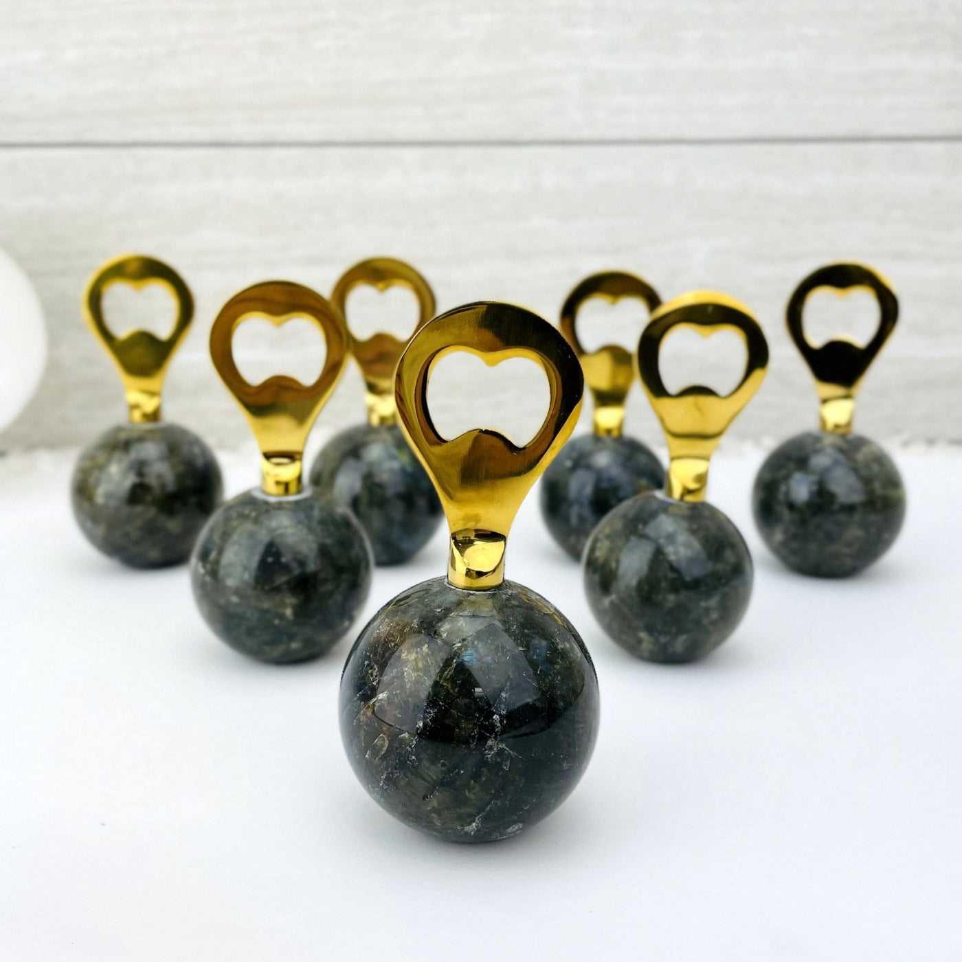 Bottle opener that has a labradorite sphere as the bottom part and a gold opener part.  Photo shows assorted openers to show slight variation in stone.