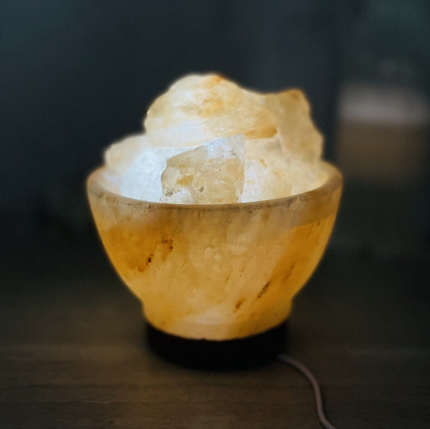 Himalayan Salt Lamp lit up in a dark room