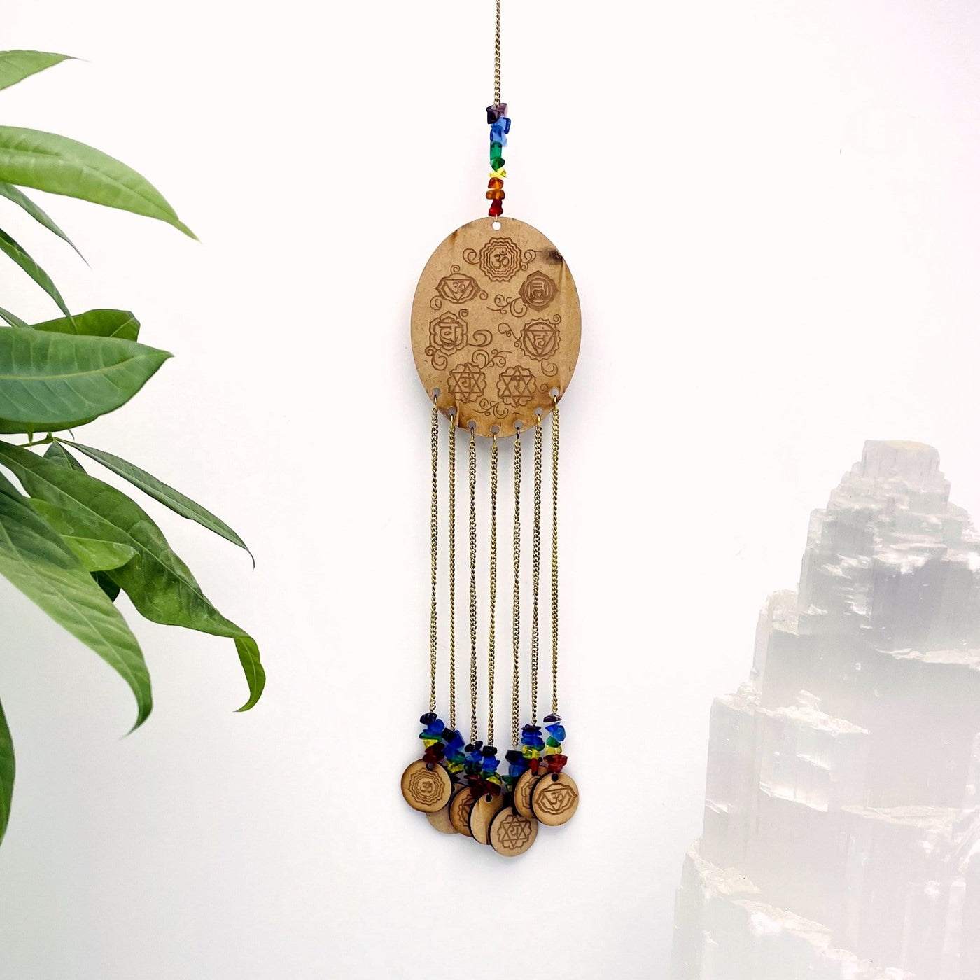 Engraved Wooden 7 Chakras hanged on white background.