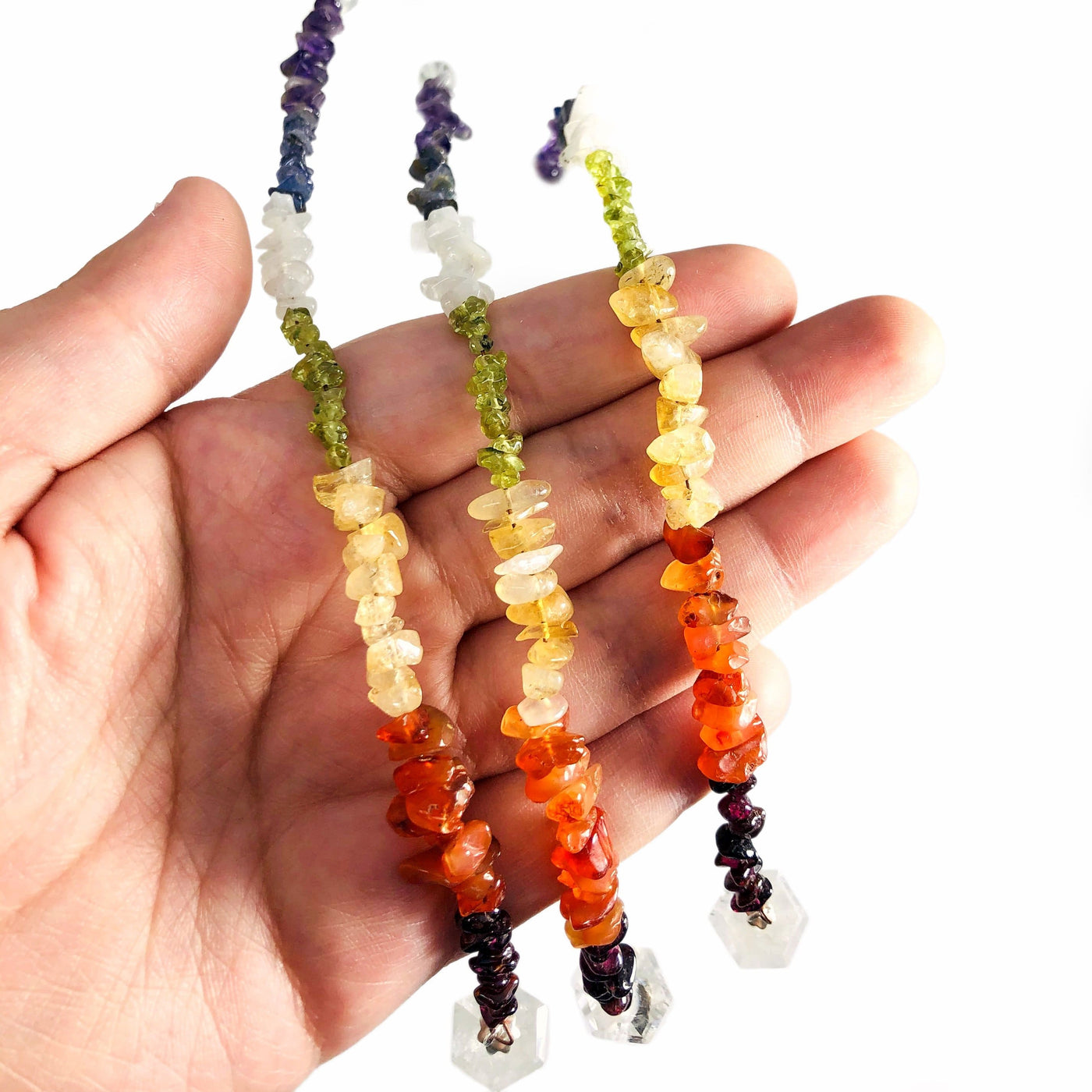 Crystal Quartz Pendulum with Chakra Beads  - close up of beads in a hand