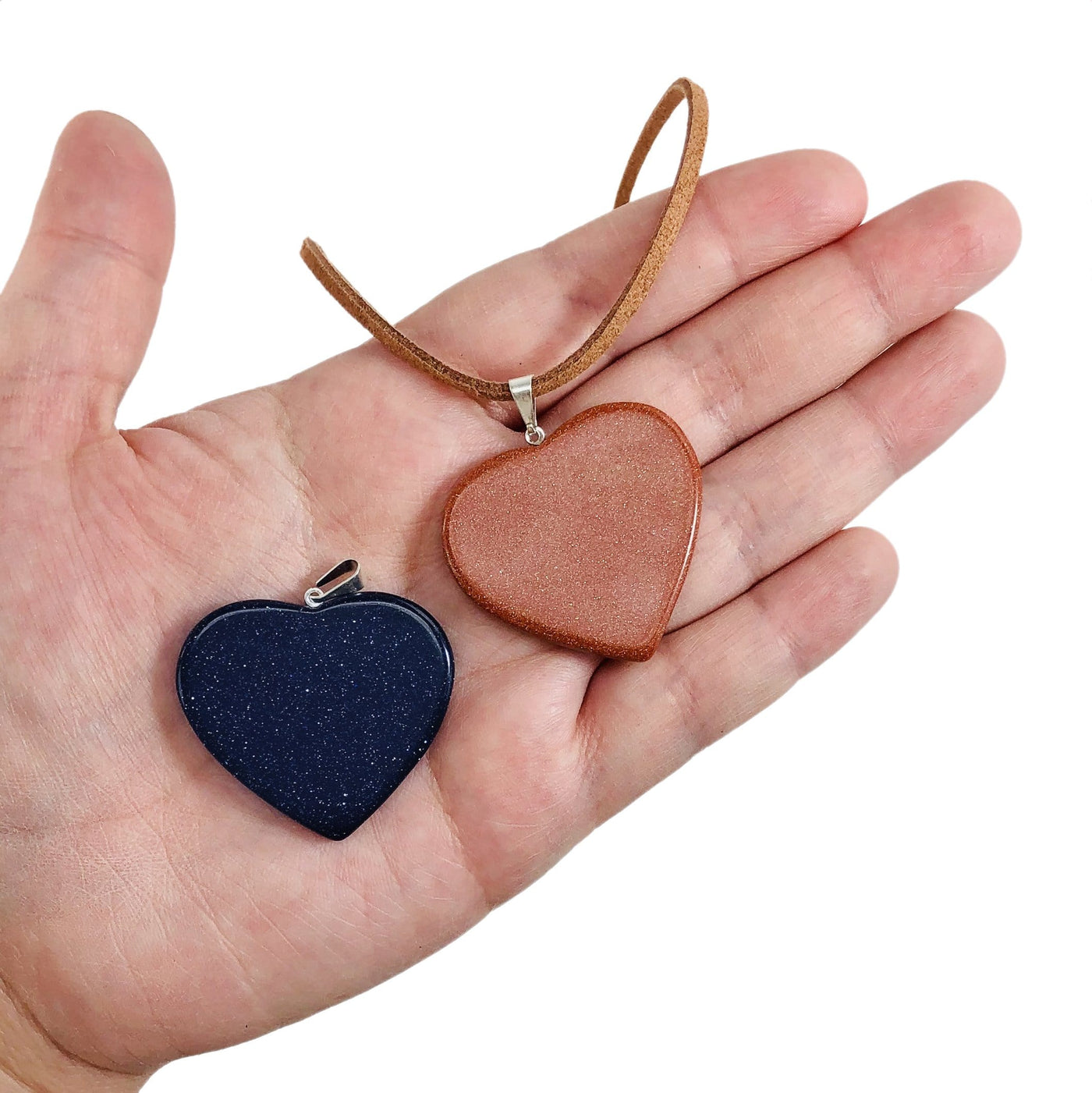 two heart slice pendants with silver toned bail with string on them to show as a neckless and one as just the pendant