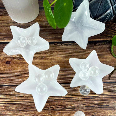 top view of 4 star selenite dishes with decorations