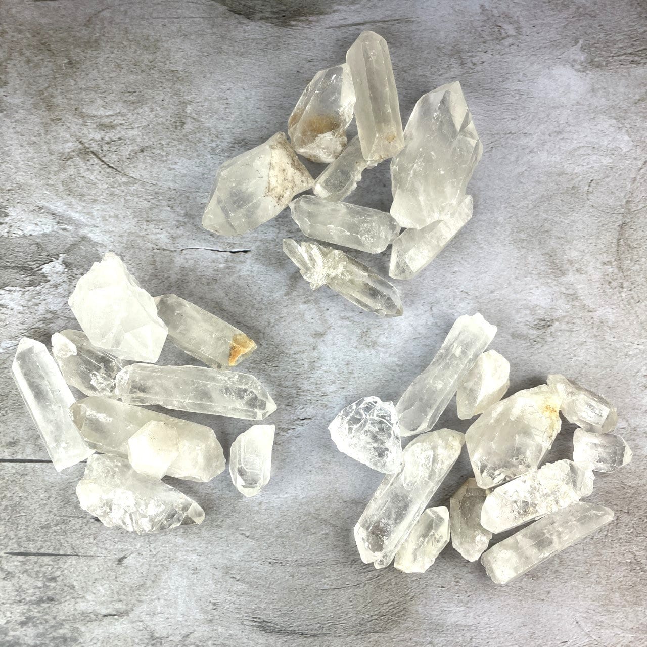 3 piles of Crystal Quartz Points - 1 Pound Bags worth