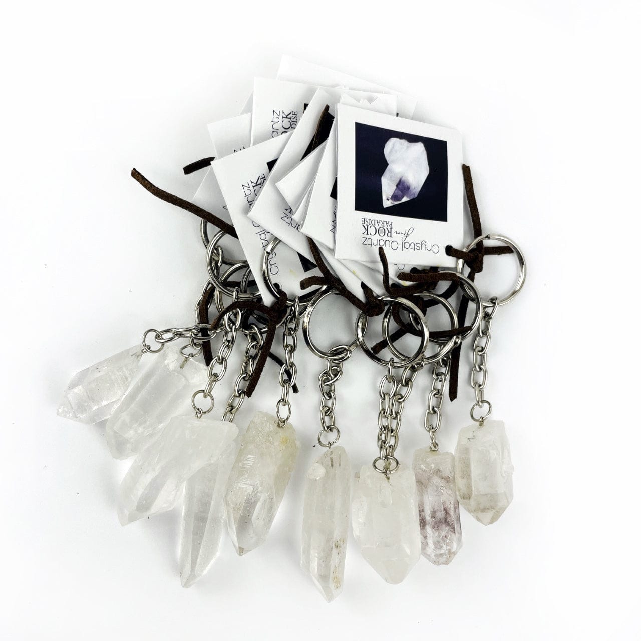 A collection of 10 Quartz crystal Point Keychains with tags tied on them
