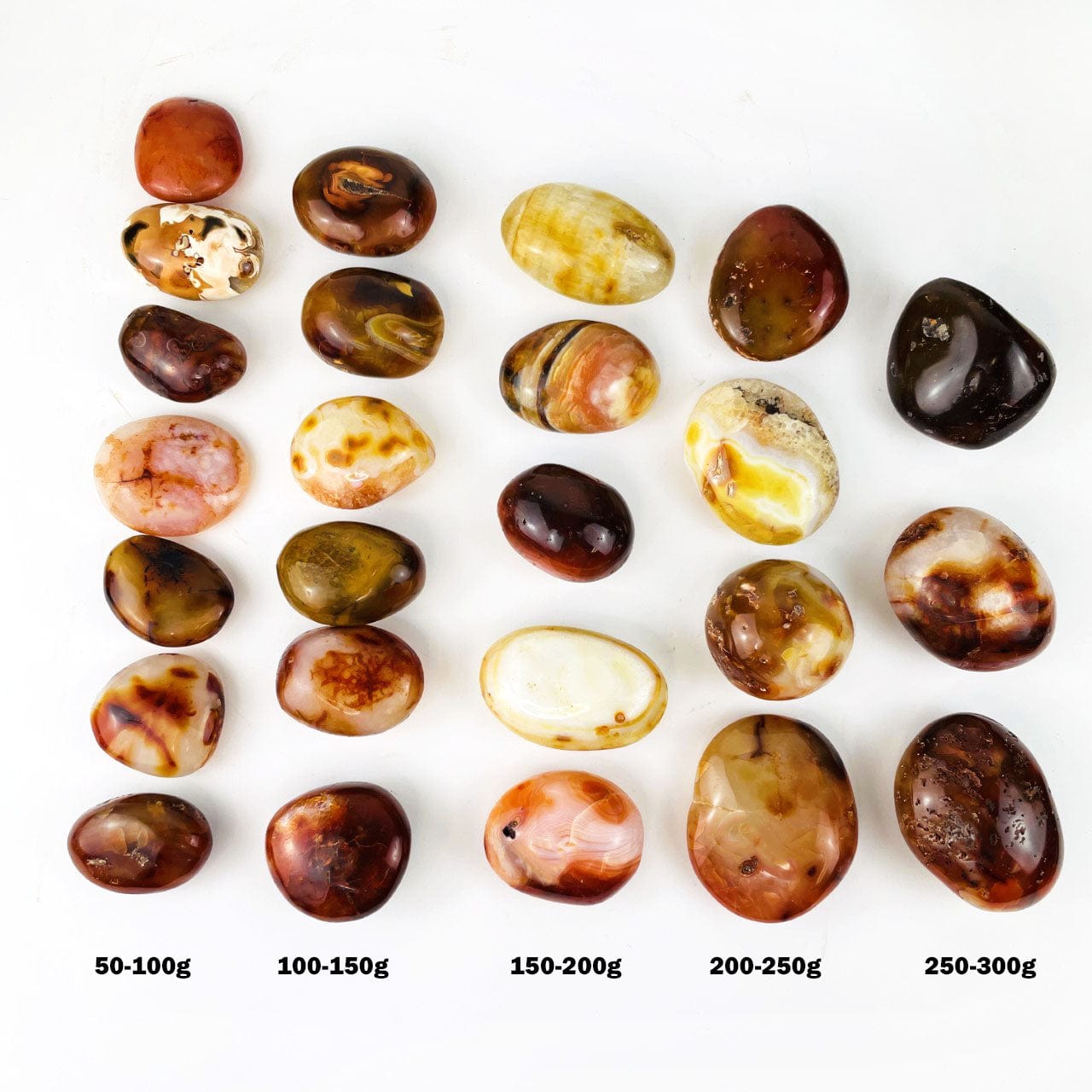 Carnelian Agate Tumbled Stones in rows showing size and color variations, type calling out sizes